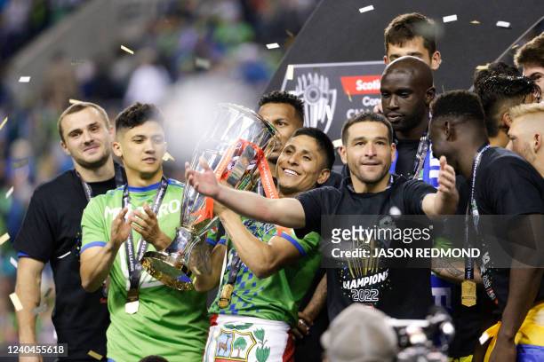 Seattle Sounders forward Raul Ruidiaz holds up the trophy as the Sounders celebrate their victory in the CONCACAF Champions League final match...