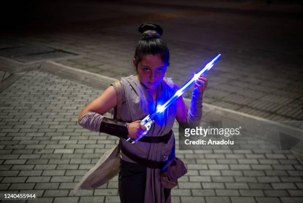 Fan of Star Wars poses for a photo with Star Wars costume and a lightsaber during the Star Wars special day in Bogota, Colombia on May 04, 2022. A...