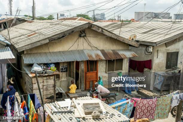 Residents in the yard outside a Face-Me-I-Face-You house in Lagos, Nigeria, on April 14, 2022. The Face-Me-I-Face-You homes found in Lagos core right...