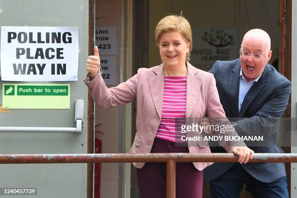 Scotland's First Minister and Scottish National Party leader Nicola Sturgeon reacts as she is surprised by her husband and current chief executive...