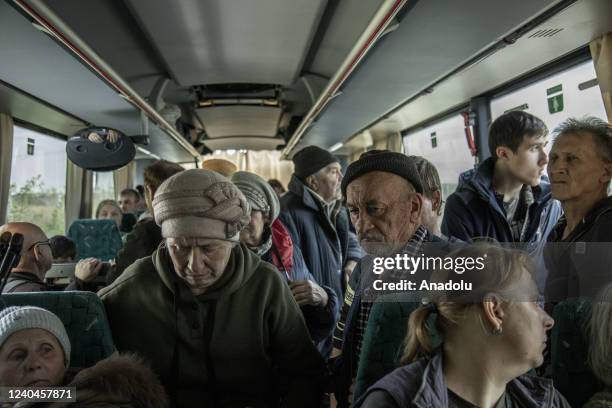 Civilians sit on a bus as they are being evacuated from the Donbas region due the fighting between Russian troops and Ukrainian forces, Slovyansk...