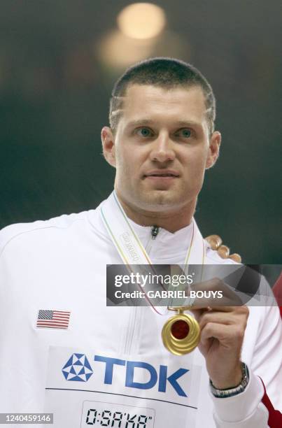 S Brad Walker poses during the men's pole vault medal ceremony at the 11th IAAF World Athletics Championships, in Osaka, 02 September 2007. USA's...