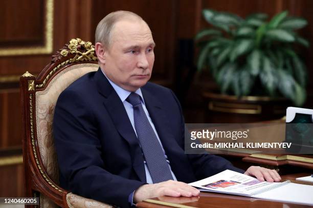 Russia's President Vladimir Putin listens during his meeting with "Znanie" Society CEO Maxim Dreval in Moscow's Kremlin on May 5, 2022. - *Editor's...