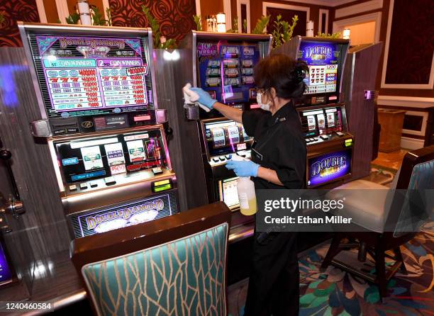 Worker sanitizes slot machines in a high-limit room for slots at Bellagio Resort & Casino as the Las Vegas Strip property, which has been closed...