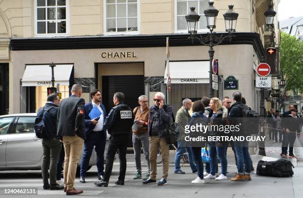 Police and investigators gather at the entrance to a Chanel shop on Place Vendome in Paris, on May 5 after a suspected armed robbery.