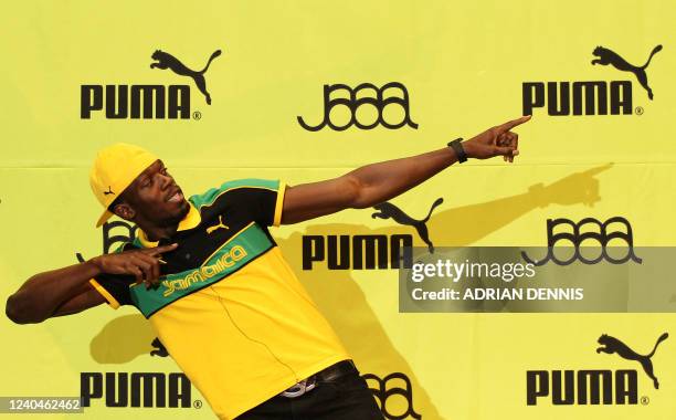 Jamaican athlete Usain Bolt does his trademark pose following a press conference by the Jamaica Athletics Administrative Association at a cultural...