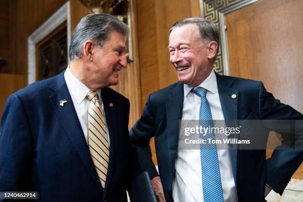 Chairman Joe Manchin, D-W.Va., left, and Sen. John Hickenlooper, D-Colo., arrive to the Senate Energy and Natural Resources Committee hearing on the...