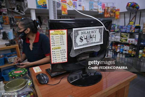 Detail of a sign showing the exchange rate of the US dollar in Bolivars at a store, in Caracas, on April 22, 2022. - After opening up to the US...