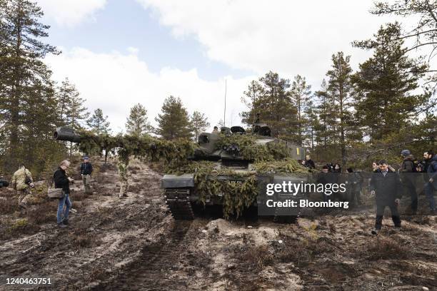 Members of the media surround a British Army Challenger 2 main battle tank during the Finnish Army Arrow 22 training exercise, with participating...
