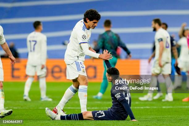 Jesus Vallejo of Real Madrid CF and Phil Foden of Manchester City shake hands after the UEFA Champions League Semi Final Leg Two match between Real...