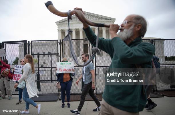 An anti-abortion demonstrator blows a shofar outside the U.S. Supreme Court on May 5, 2022 in Washington, DC. Protestors on both sides of the...