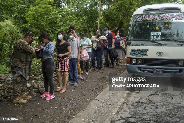 Soldiers check civilians at a military checkpoint in the town of Tonacatepeque on May 5, 2022 in San Salvador, El Salvador. The Legislative Assembly...