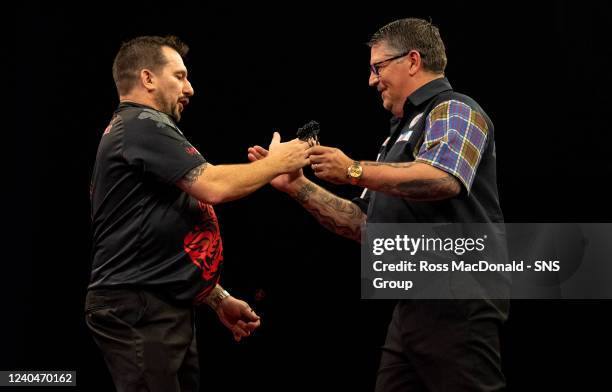 Gary Anderson shakes hands with semi-final winner Jonny Clayton during a Cazoo Premier League Darts event at the OVO Hydro, on May 05 in Glasgow,...