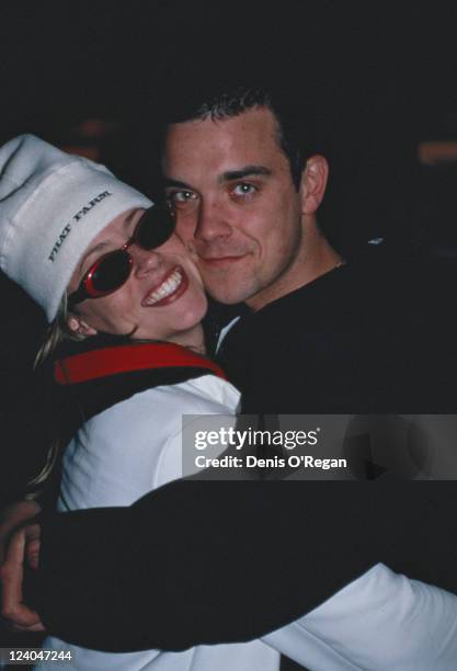 English singer Robbie Williams embraces singer Nicole Appleton of All Saints at the MTV Europe Music Awards in Milan, Italy, 12th November 1998. She...