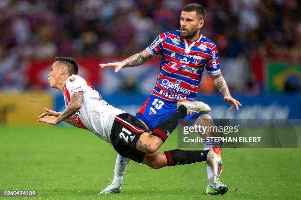 Argentina's River Plate Ezequiel Barco falls next to Brazil's Fortaleza Lucas Lima during their Copa Libertadores group stage football match, at the...
