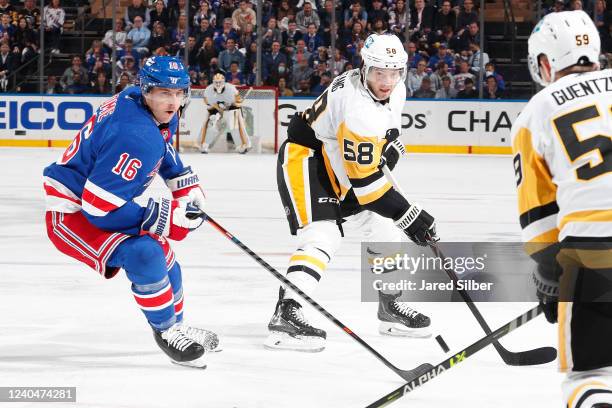 Kris Letang of the Pittsburgh Penguins plays the puck against Ryan Strome of the New York Rangers in Game Two of the First Round of the 2022 Stanley...