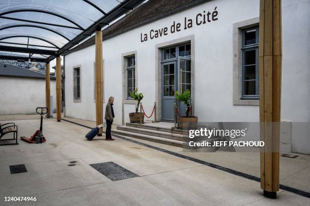 Woman stands in front of the Cave de la Cité in the culinary village of the new Cité Internationale de la Gastronomie et du Vin, on May 5, 2022 in...