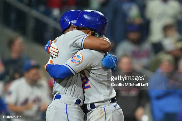 Starling Marte of the New York Mets hugs Francisco Lindor after a two run home run by Lindor in the top of the ninth inning against the Philadelphia...