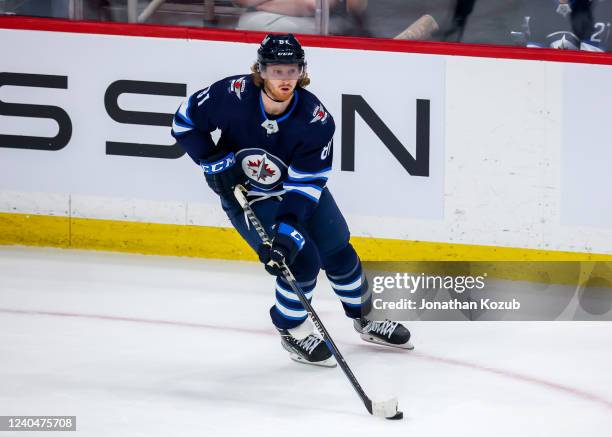 Kyle Connor of the Winnipeg Jets plays the puck during third period action against the Calgary Flames at Canada Life Centre on April 29, 2022 in...