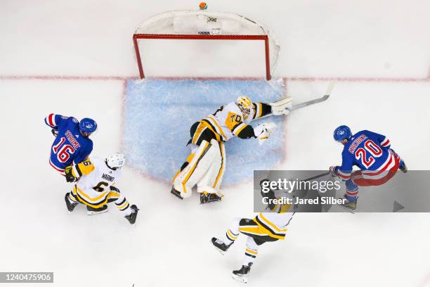 Louis Domingue of the Pittsburgh Penguins makes a save against Chris Kreider of the New York Rangers in Game Two of the First Round of the 2022...