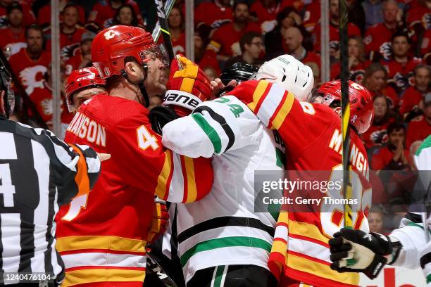 Erik Gudbranson of the Calgary Flames wrestles with Denis Gurianov of the Dallas Stars in Game Two of the First Round of the 2022 Stanley Cup...