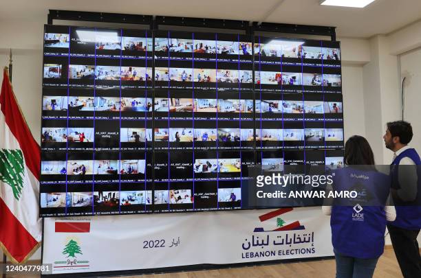 Members of Lebanon's election monitoring association survey the voting process through screens at the foreign ministry in Beirut on May 6, 2022. -...