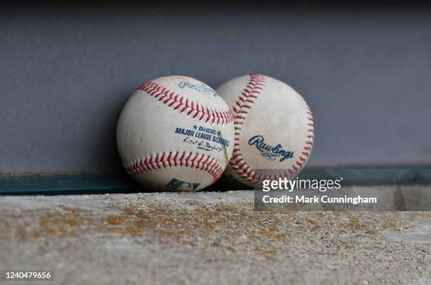Detailed view of a pair of game used official Rawlings Major League baseballs sitting in the dugout during game two of a doubleheader between the...