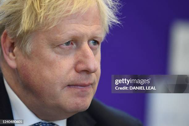 Britain's Prime Minister Boris Johnson reacts as he visits with teachers the Field End Infant school, in South Ruislip, on May 6, 2022. - Prime...