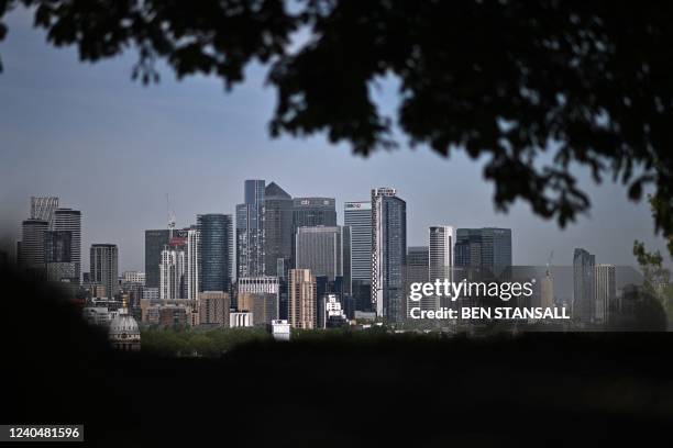 View of London's secondary central business district of Canary Wharf, seen from Greenwich Park in the spring sunshine on May 6, 2022. - The Bank of...