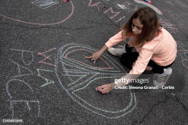 Child writes Viva la Pace in front of the Ministry of Education during the school strike and demonstration , on May 6, 2022 in Rome, Italy. Teachers,...