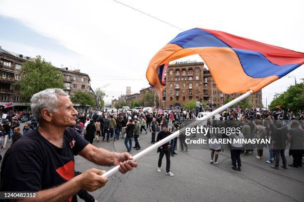 Man waves a national flag during a rally called by opposition parties in a bid to oust Prime Minister over his handling of a territorial dispute with...