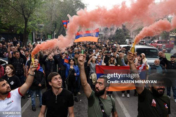 Protesters hold Armenian and Nagorno-Karabakh republic national flags during a rally called by opposition parties in a bid to oust Prime Minister...