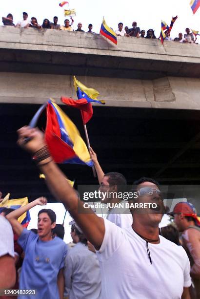 Demonstrators against Venezuelan President Hugo Chavez wave flags 05 December during a protest march in Caracas. Protesters are on the fourth day of...