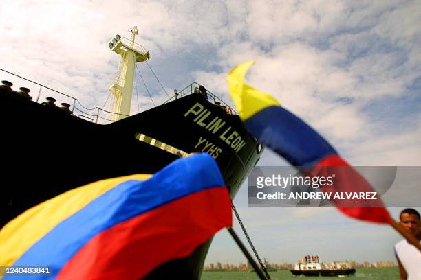 Venezuelan flags fly in front of the oil tanker Pilin Leon, which is stationed in Lago de Maracaibo with 44 million liters of gasoline, 19 December...