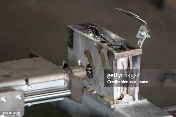 May 2022, Lower Saxony, Goslar: View of the nail test with a lithium-ion battery, which has broken down during a demonstration in a container on the...