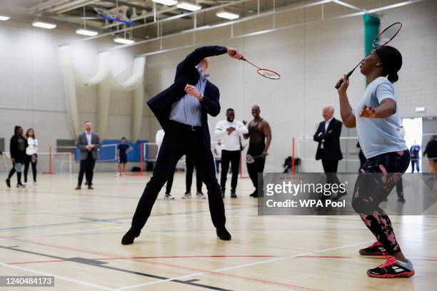Prince William, Duke of Cambridge plays badminton alongside Garcia Foster-Welter during a visit to Sports Key on May 6, 2022 in Birmingham, England.