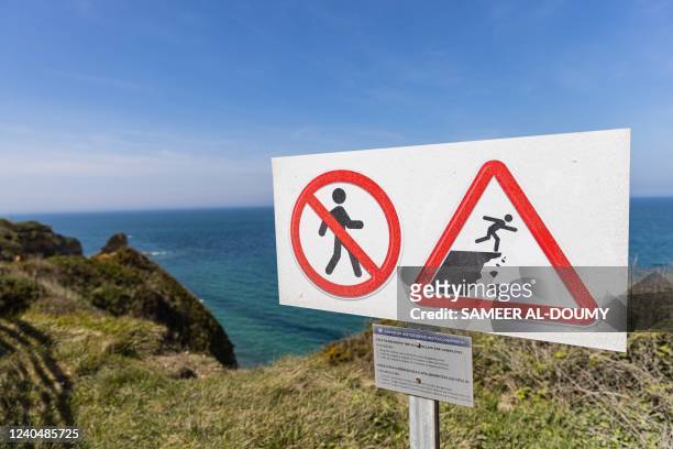 Picture taken on May 6 shows a warning sign near the recently collapsed part of the "Pointe du Hoc", a clifftop in Cricqueville-en-Bessin, on the...