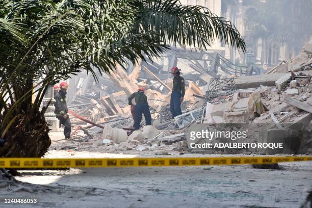 Rescuers work after an explosion in the Saratoga Hotel in Havana, on May 6, 2022. - A powerful explosion Friday destroyed part of a hotel under...