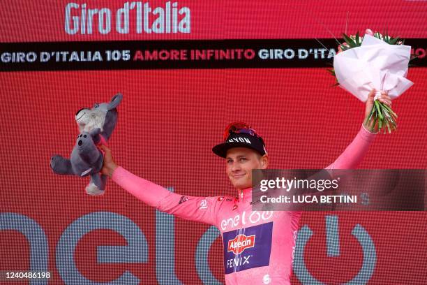 Team Alpecin-Fenix Dutch rider Mathieu van der Poel, wearing the overall leader's pink jersey, celebrates on the podium after winning the first stage...