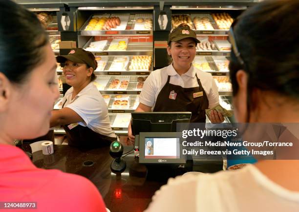 Downey, CA Danielle Renteria. Right, and Jessica Vasquez, left, serves customers at Southern California's 2nd Dunkin Donuts location at the stores...