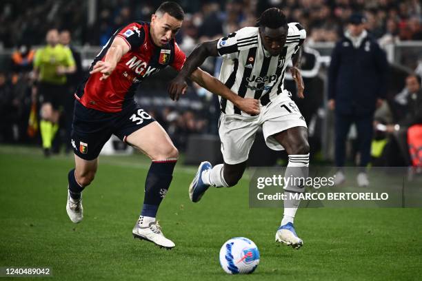 Juventus' Italian forward Moise Kean outflanks Genoa's Swiss defender Silvan Hefti during the Italian Serie A football match between Genoa and...