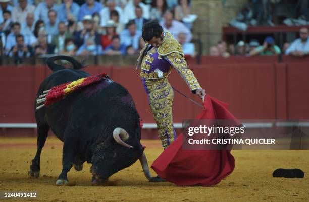 Spanish bullfighter Morante de La Puebla performs a pass with muleta during the Feria de Abril bullfighting festival at La Maestranza bullring in...