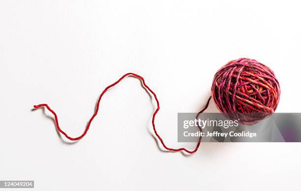 ball of red yarn on white - ball of wool ストックフォトと画像