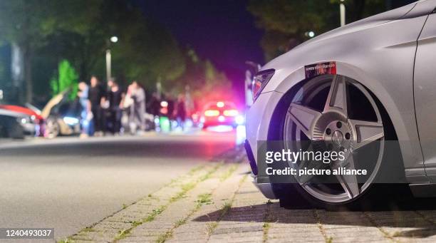 May 2022, Lower Saxony, Hanover: Interested people walk between tuned vehicles at the Expo Park. Once again, hundreds of car tuners and car...