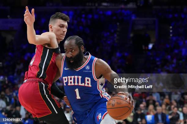 James Harden of the Philadelphia 76ers drives to the basket against Tyler Herro of the Miami Heat in the first half during Game Three of the 2022 NBA...