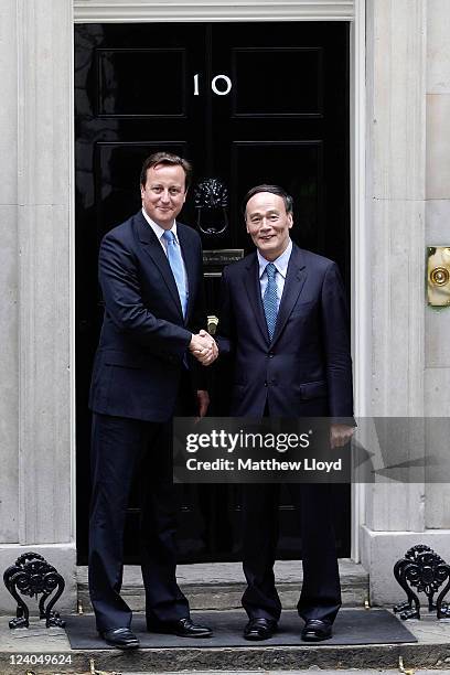 Prime Minister David Cameron and Chinese Vice President Wang Qishan shake hands outside Number 10 Downing Street on September 8, 2011 in London,...