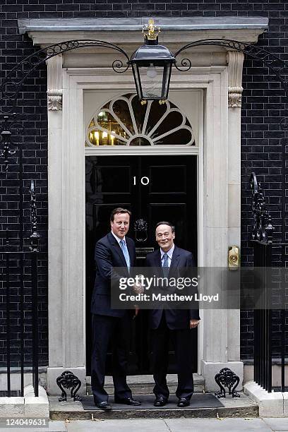 Prime Minister David Cameron and Chinese Vice President Wang Qishan shake hands outside Number 10 Downing Street on September 8, 2011 in London,...