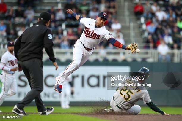 Stephen Piscotty of the Oakland Athletics steals second base as Jorge Polanco of the Minnesota Twins cannot field the ball in the second inning of...