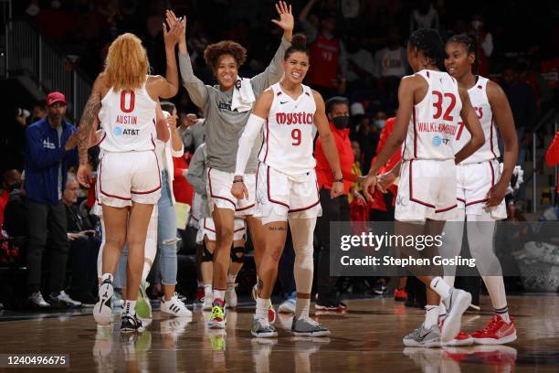 Tianna Hawkins and Natasha Cloud of the Washington Mystics react to a play during the game against the Indiana Fever on May 6, 2022 at Entertainment...