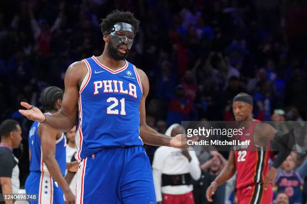 Joel Embiid of the Philadelphia 76ers reacts in front of Jimmy Butler of the Miami Heat after making a basket and getting fouled in the second half...